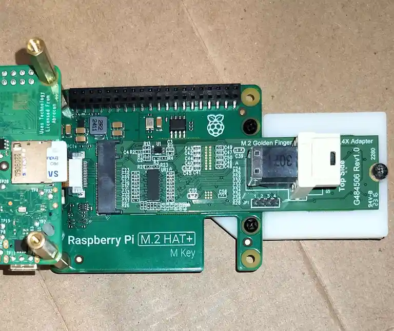 A close-up photo of a green Raspberry Pi M.2 HAT+ expansion board, which is an add-on for Raspberry Pi computers to connect…