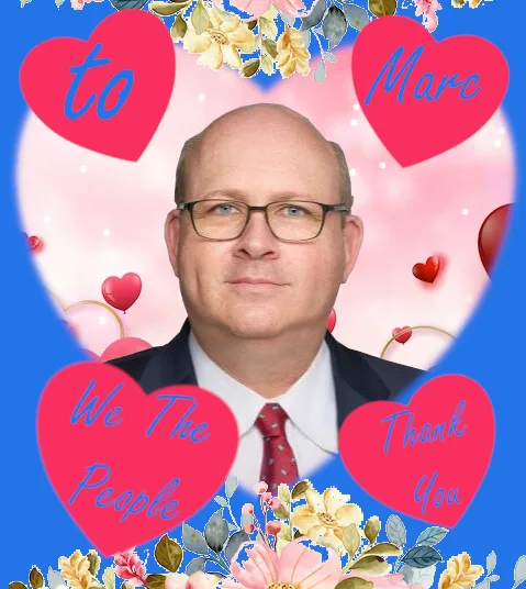 A man in glasses and a suit is framed by a heart-shaped border with floral decorations. Four red hearts surround him…
