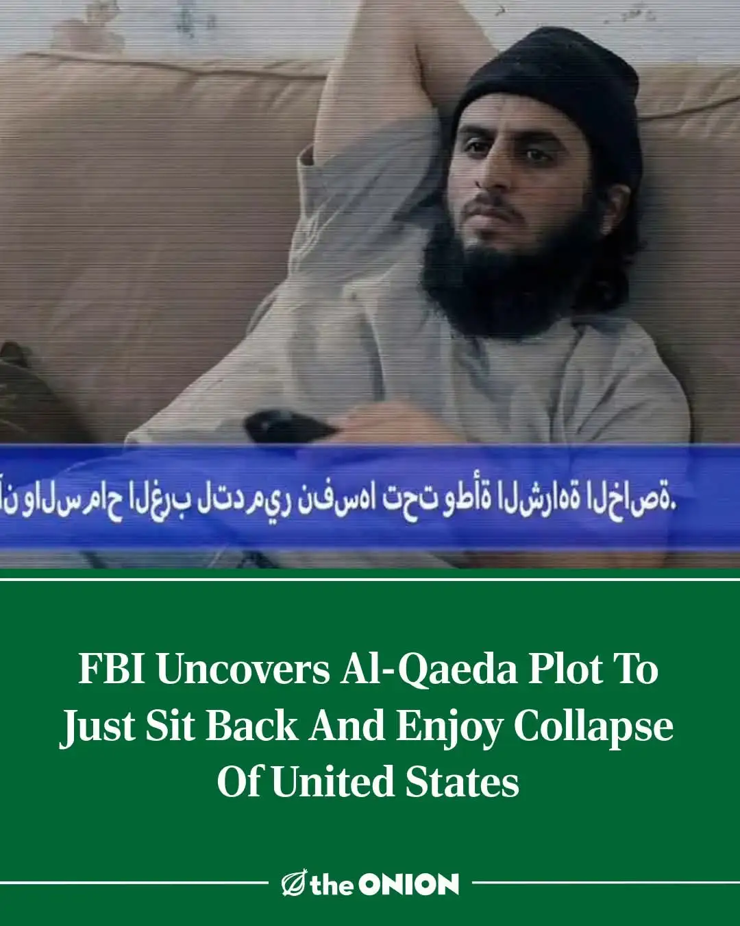 A man with a beard and black beanie lounges on a couch, holding a remote, looking relaxed. A blue news ticker in Arabic runs…