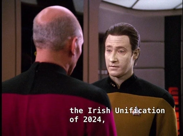 A still from Star Trek: The Next Generation shows Captain Jean-Luc Picard (back to camera, in a red uniform) facing…