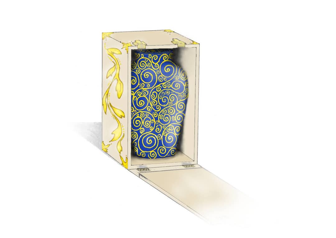 a blue and gold patterned vase is displayed inside an ornate, cream-colored presentation box with gold leaf accents on the…