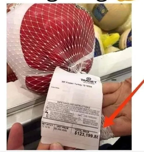 A person holds a price tag for a frozen turkey at Target, where the total price is absurdly listed as $123,199.86, with a…
