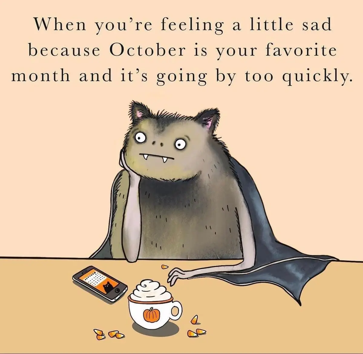 A cartoon bat with a sad expression sits at a table, hand on chin, looking at a smartphone and a pumpkin-themed mug with…