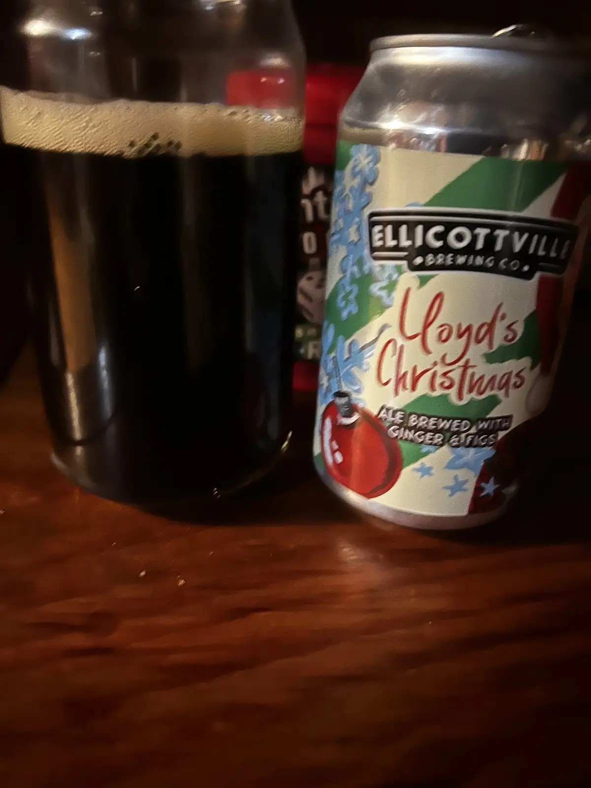 A close-up photo shows a silver can of Ellicottville Brewing Co.'s 'Lloyd's Christmas' ale, decorated with holiday-themed…
