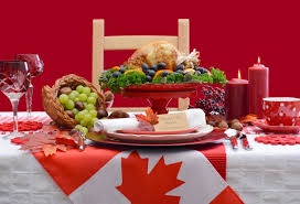 A festive Thanksgiving dinner spread is set on a table covered with a Canadian flag, featuring a roasted turkey, cranberry…