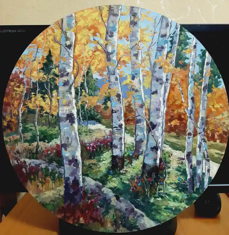 A circular painting of birch trees with white bark and autumnal yellow and orange leaves, set against a blue sky and green…