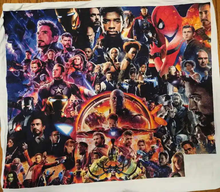 A white towel printed with the 'Avengers: Endgame' movie poster, featuring a dense collage of numerous Marvel superheroes…