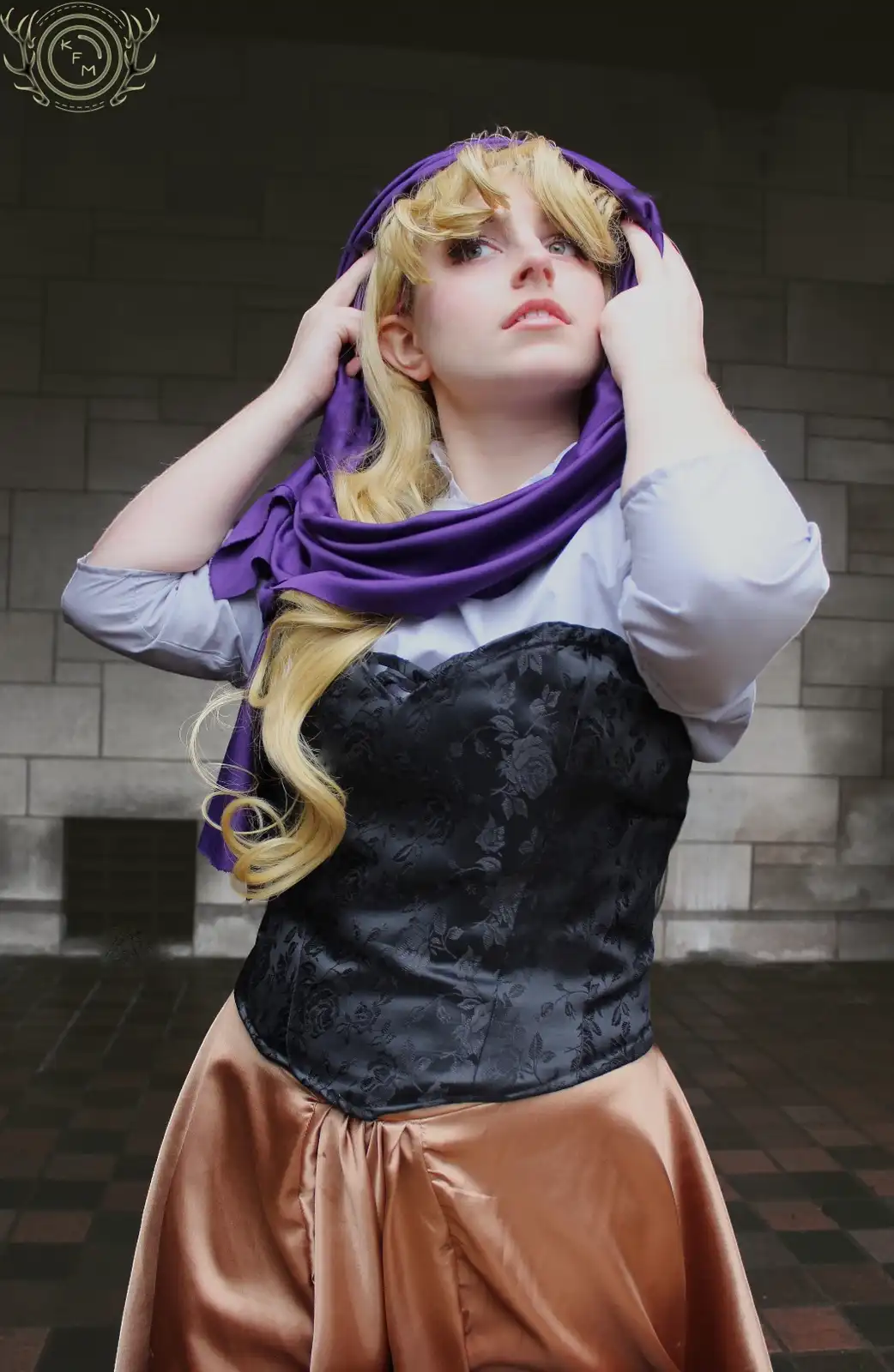 A person in a cosplay of Rapunzel, wearing a black corset, tan skirt, and a purple scarf, looks upward with hands adjusting…