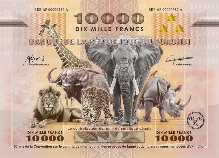 This image is a 10,000 francs banknote from the Banque de la République du Burundi, featuring a central elephant surrounded…