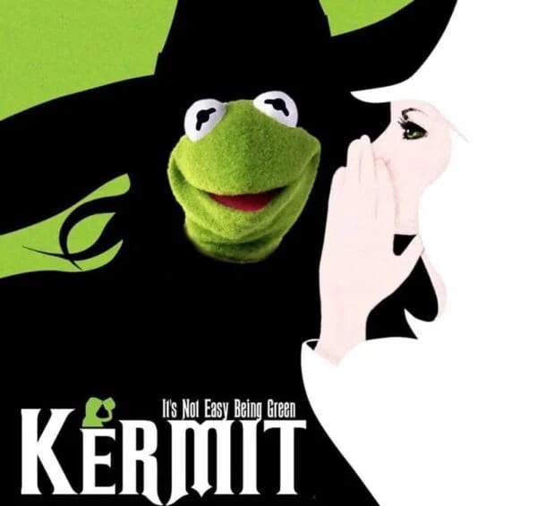 A green frog puppet, Kermit, is depicted wearing a black witch's hat and cloak, with a stylized green witch's hand reaching…