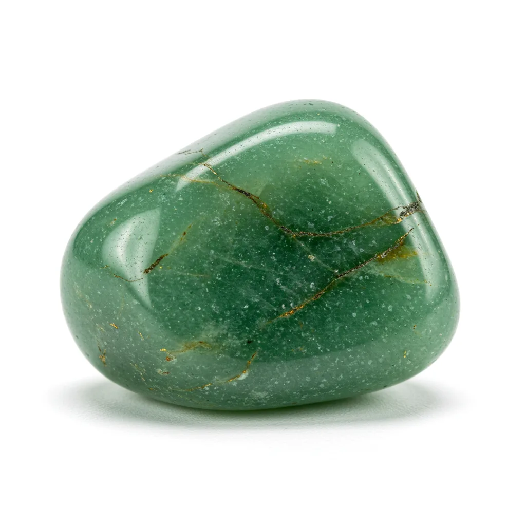 A smooth, polished green stone with golden veins and white speckles sits against a plain white background. The overlaid text…