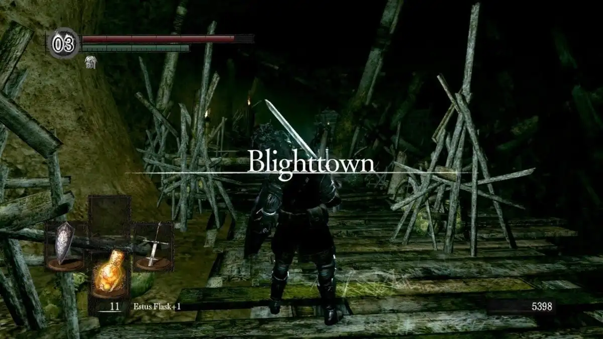 A screenshot from the video game Dark Souls showing a player character in dark armor standing in a dilapidated wooden…