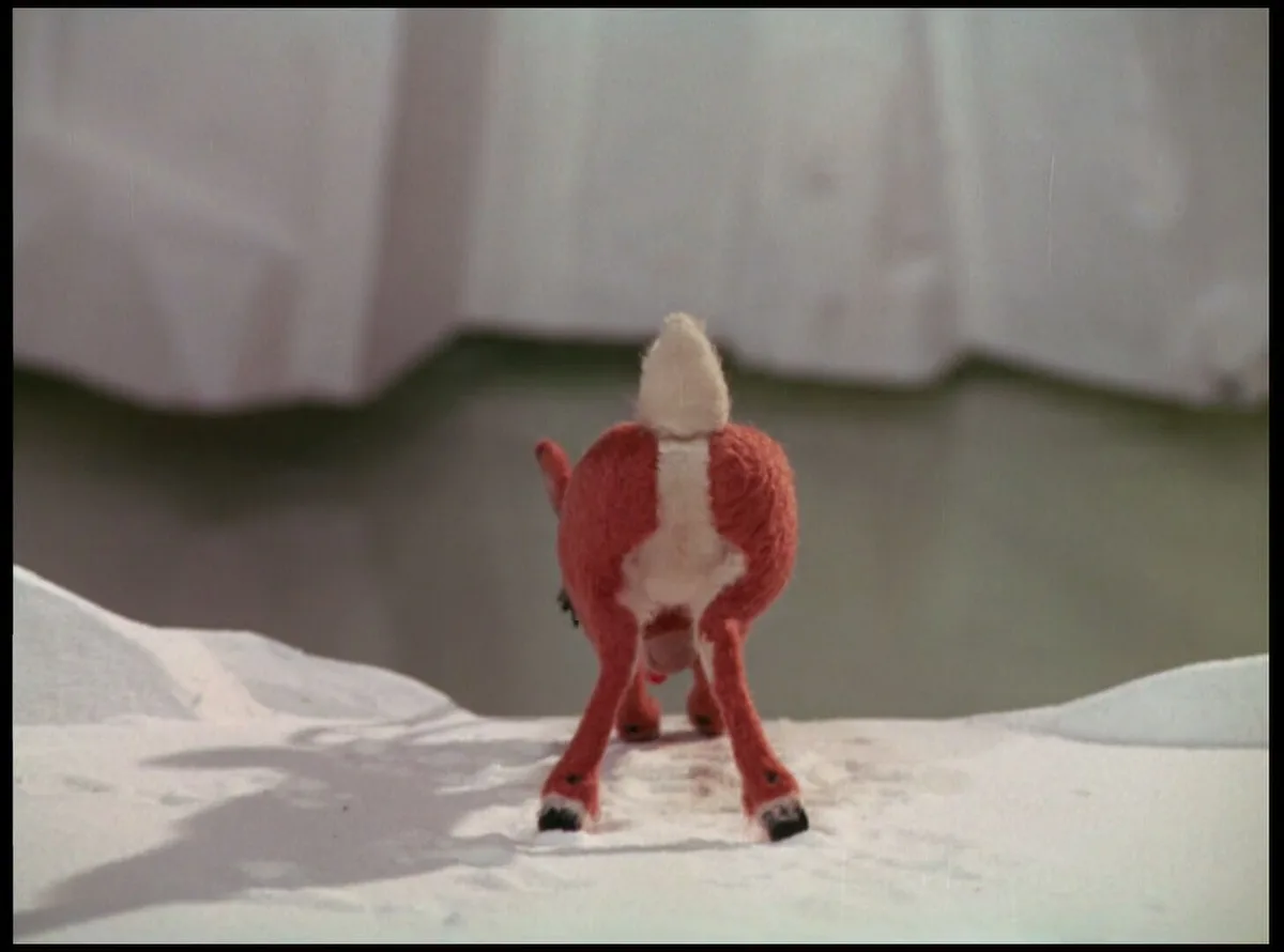 A still image from the 1964 animated film 'Rudolph the Red-Nosed Reindeer' shows the titular character, a small red and…