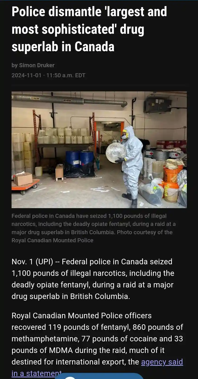 A news article screenshot shows a police officer in a full hazmat suit carrying a large, round, foil-wrapped object through…