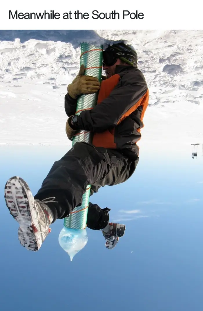 A person in winter gear is shown upside down, clinging to a large, cylindrical object wrapped in reflective material, with a…