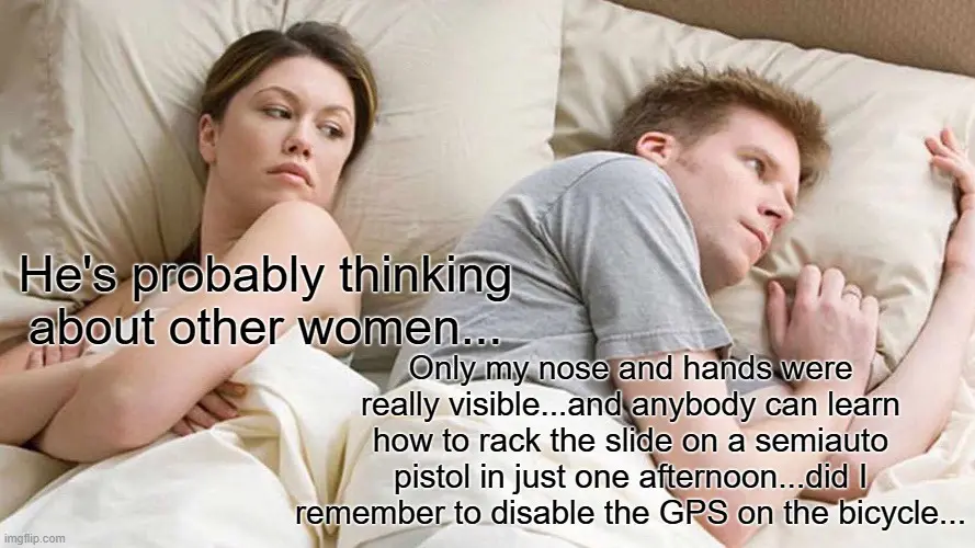 A man and woman lie in bed, the woman looking away with a skeptical expression while the man looks at her. Text overlaid on…