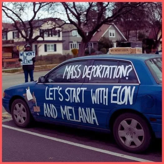 A blue car with white handwritten text on its windows and side reading 'MASS DEPORTATION? LET'S START WITH ELON AND…