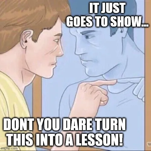 A cartoon depicts a person in a yellow shirt pointing at their own reflection in a mirror, which shows a blue-toned version…