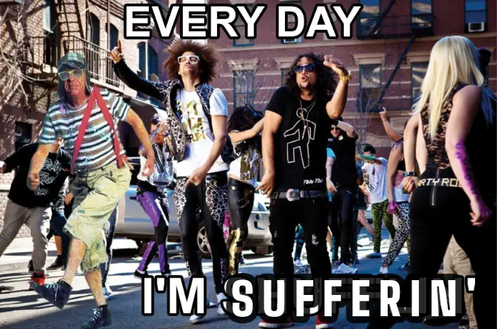 A group of people dressed in flamboyant, colorful street clothes are dancing energetically on a city sidewalk in front of…