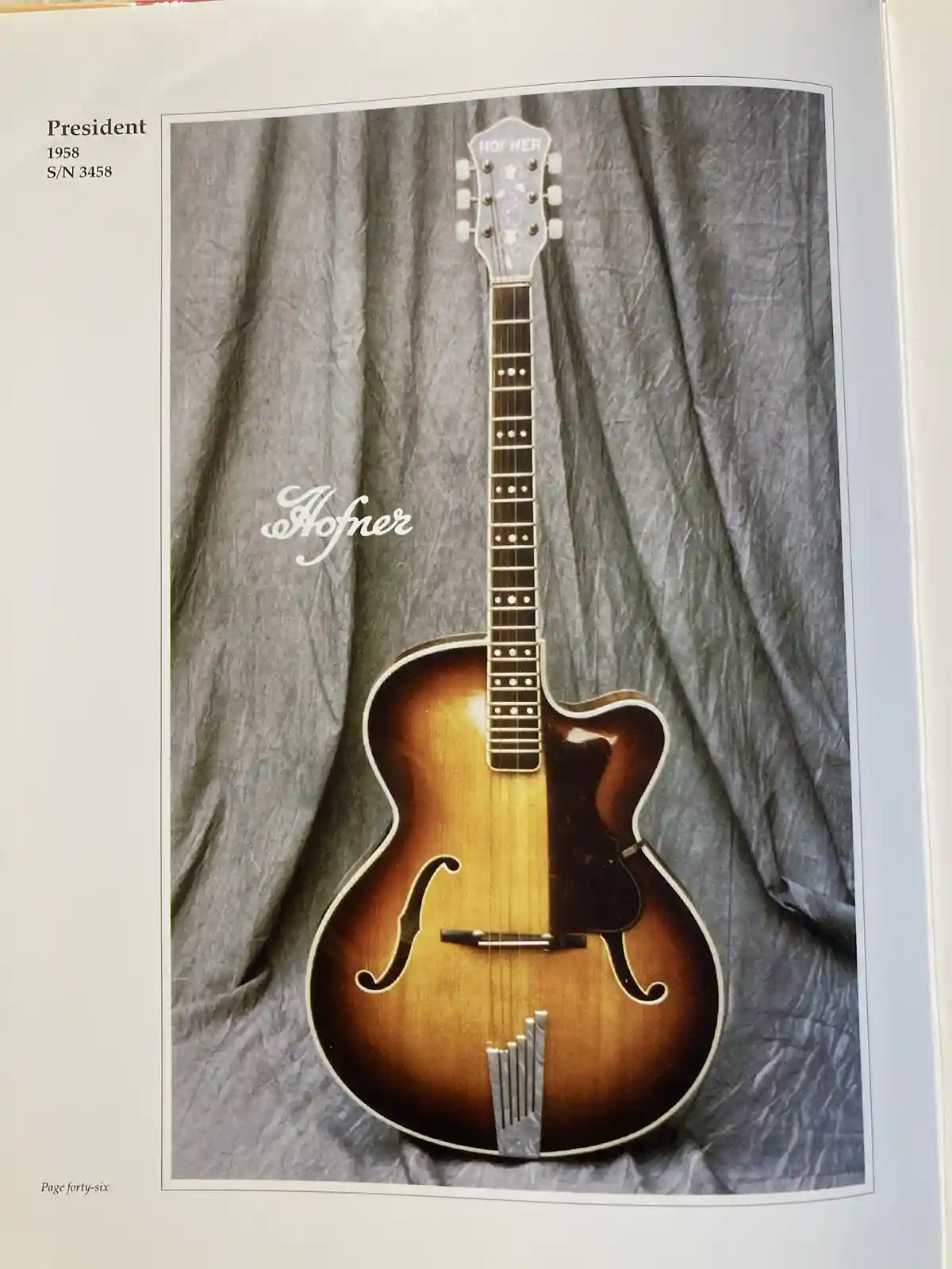 A vintage 1958 Hofner President archtop guitar with serial number 3458 is shown in a catalog photo against a grey fabric…