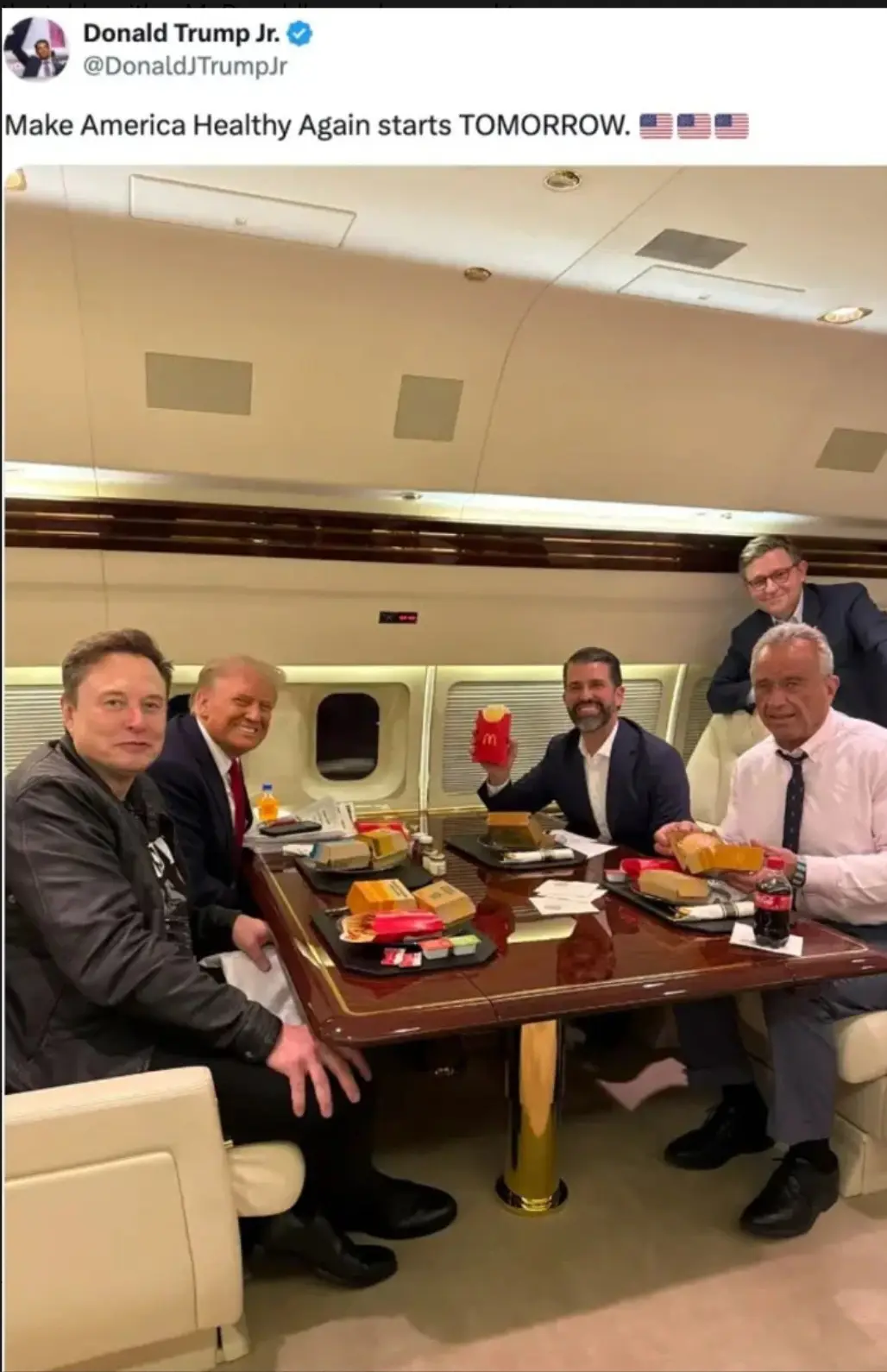 A screenshot of a tweet from Donald Trump Jr. shows him and several men, including Elon Musk and Donald Trump, seated around…