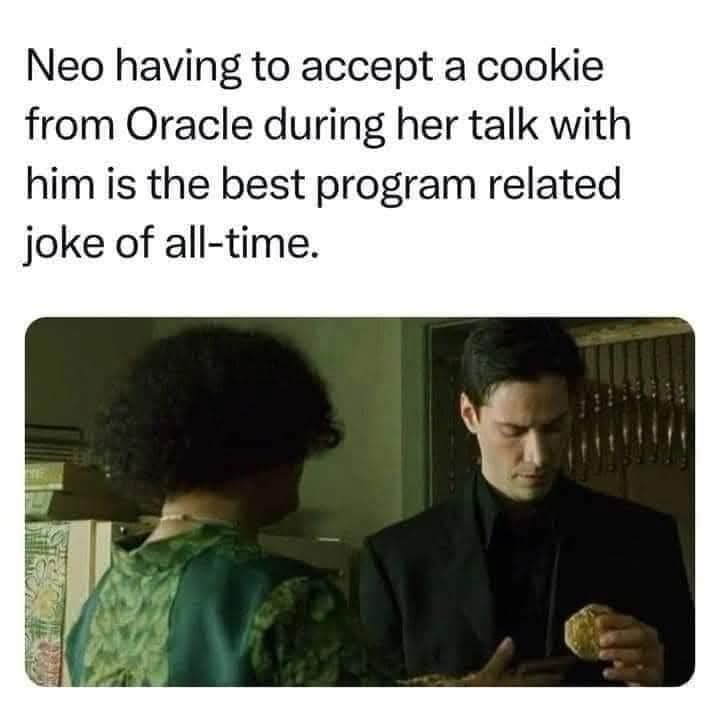 A still from 'The Matrix' shows Neo, in a black suit, reluctantly accepting a cookie from the Oracle, who is facing him in a…