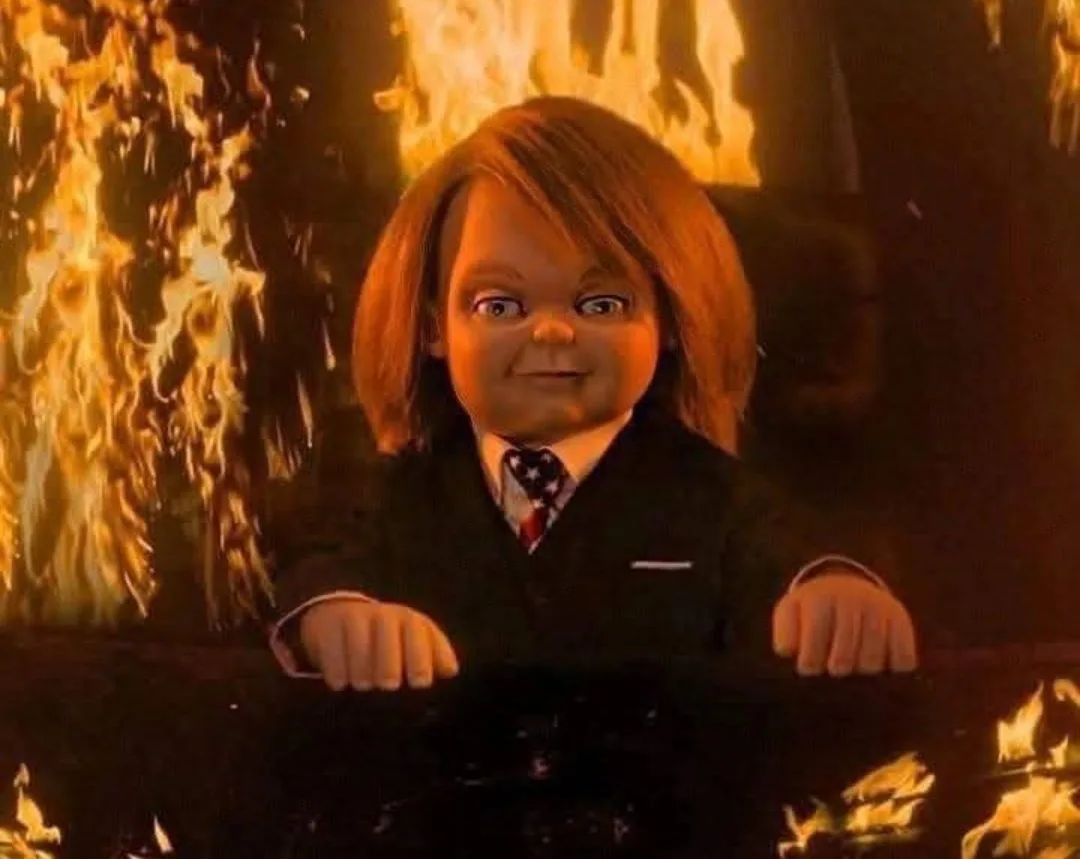 a still image of the horror doll Chucky from the 'Child's Play' franchise, shown with a smug, unsettling grin while…
