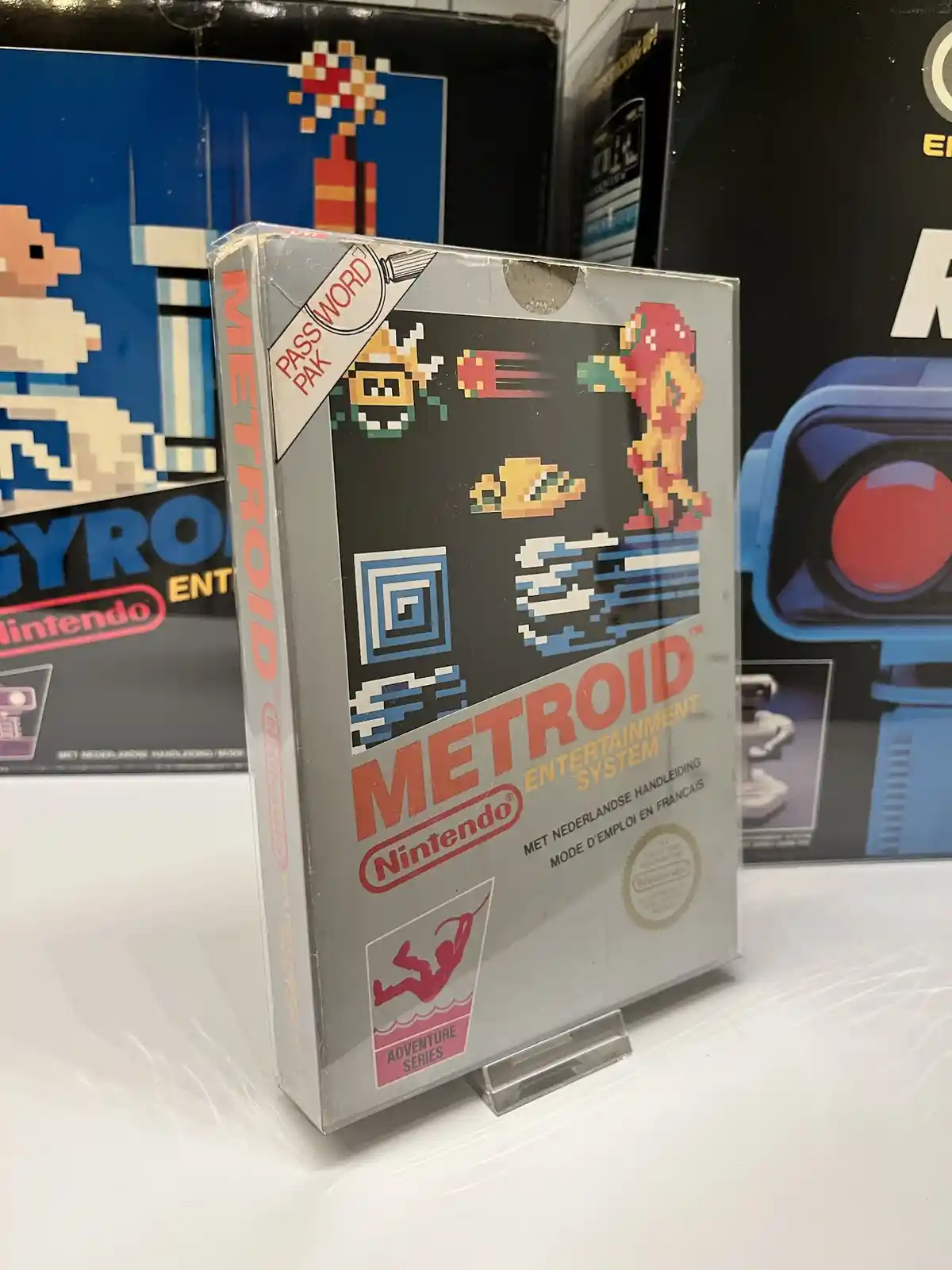 A close-up photo of a vintage Nintendo Entertainment System game cartridge for 'Metroid', standing upright in a clear…