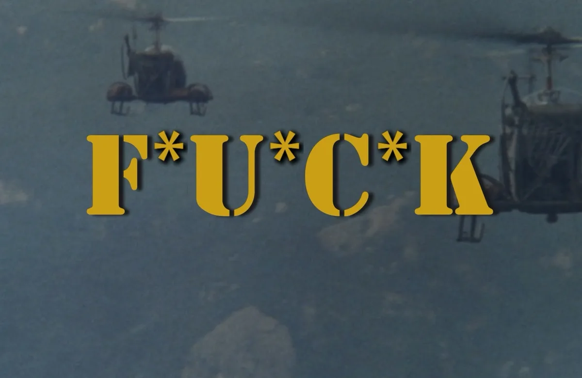 Two helicopters fly in formation over a cloudy sky, with the word 'F*U*C*K' in large yellow letters overlaid across the…
