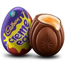 A Cadbury Creme Egg chocolate egg is shown whole on the left and broken open on the right, revealing its creamy yellow…