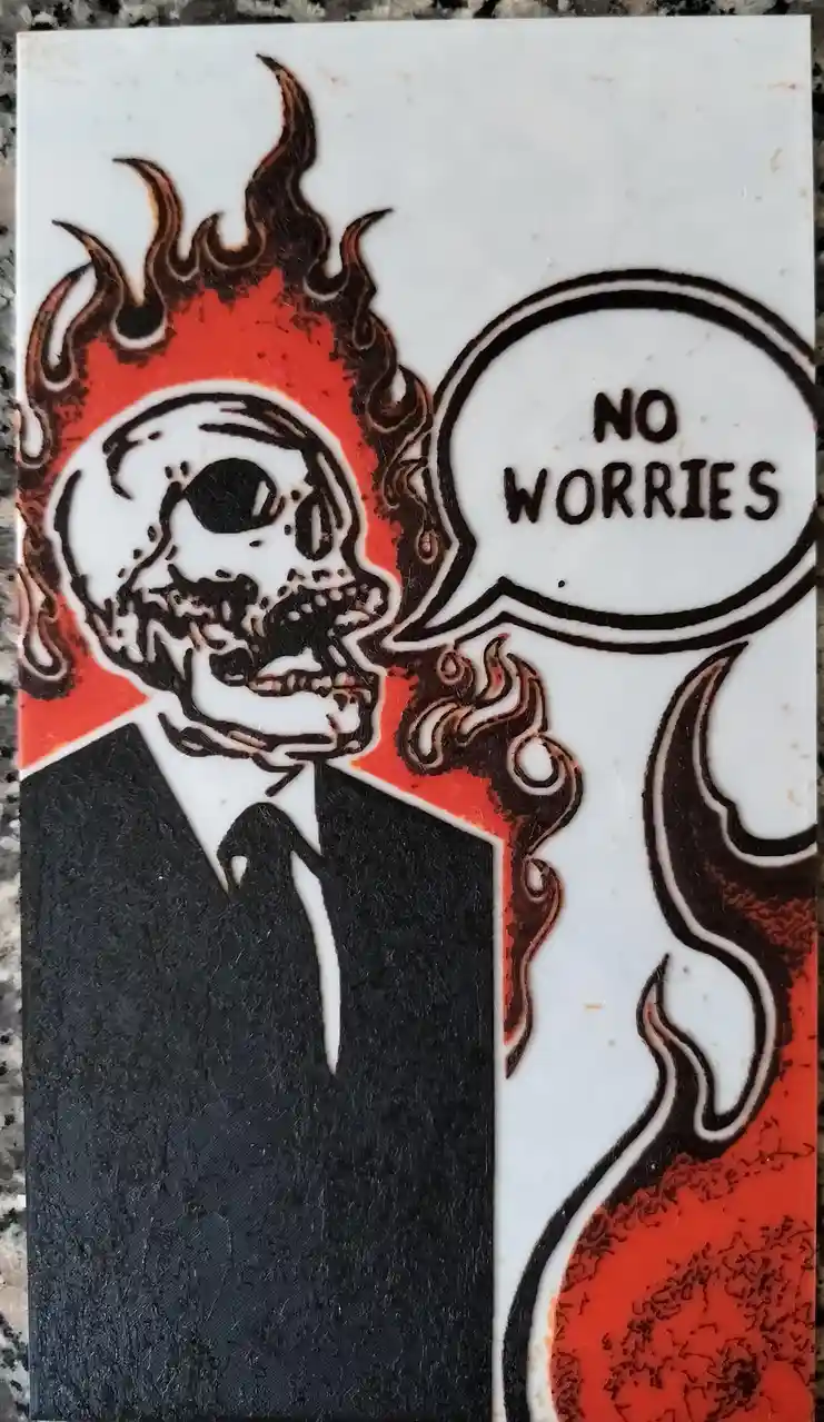 A stylized illustration of a flaming skull wearing a black suit and tie, with a speech bubble saying 'NO WORRIES'. The skull…