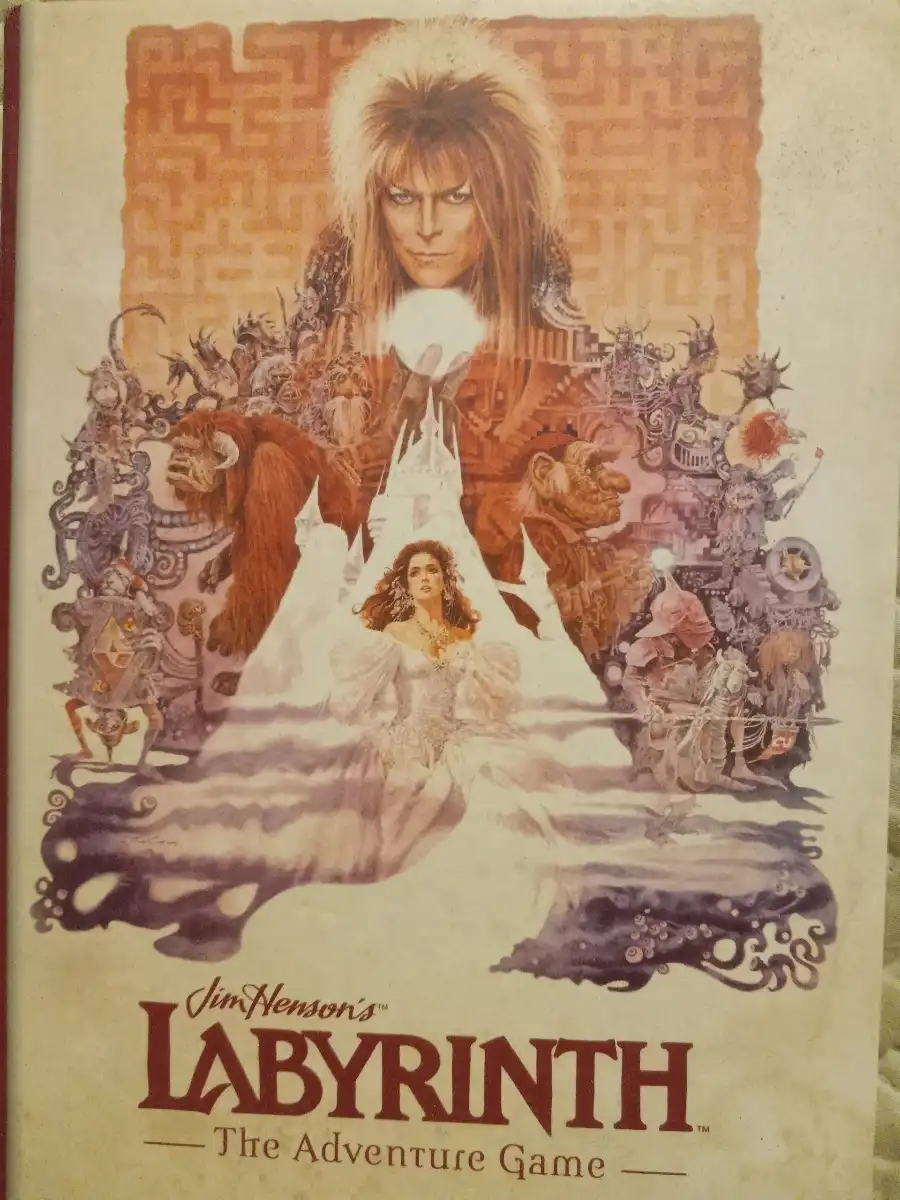 The image shows the cover art for 'Jim Henson's Labyrinth — The Adventure Game,' featuring a central figure with long hair…