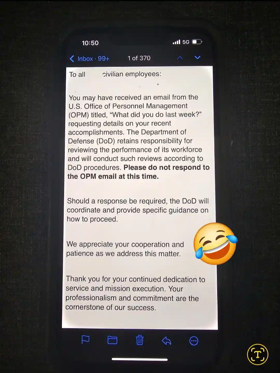 A smartphone screen displays an official-looking email from the U.S. Department of Defense addressed to civilian employees…