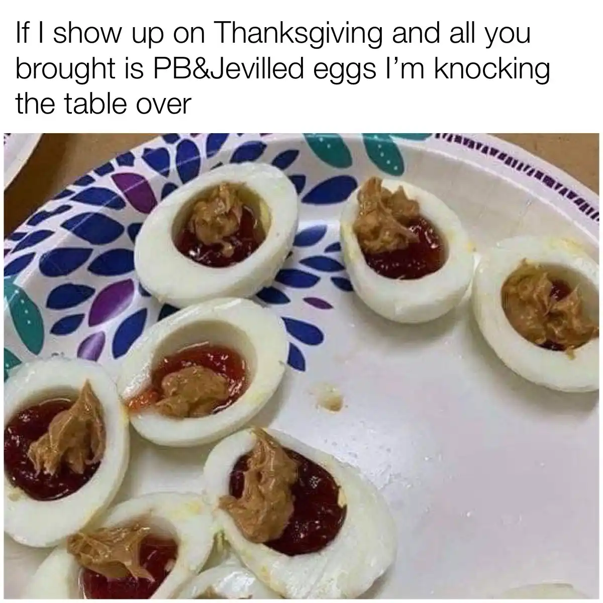 A close-up photo shows several halved hard-boiled eggs on a patterned paper plate, each filled with peanut butter and jelly…