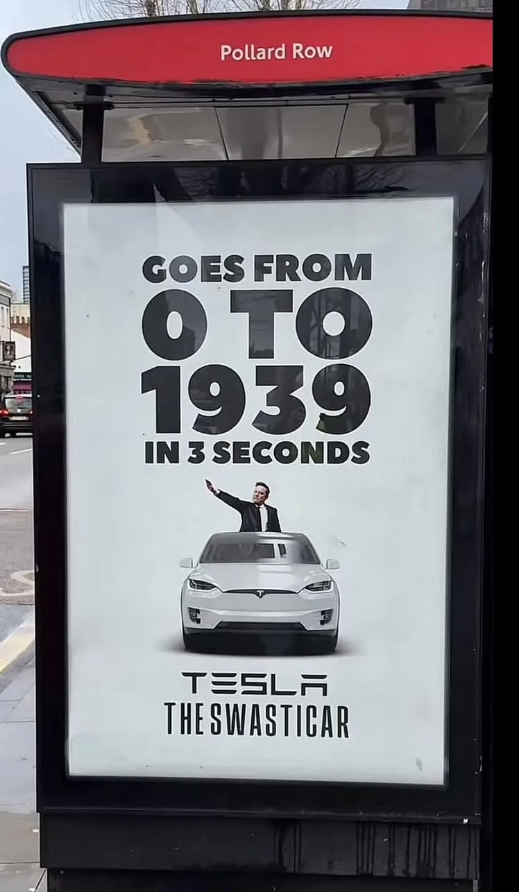 A bus stop advertisement for Tesla features a white car and a man in a suit pointing upward. The text claims the car 'goes…
