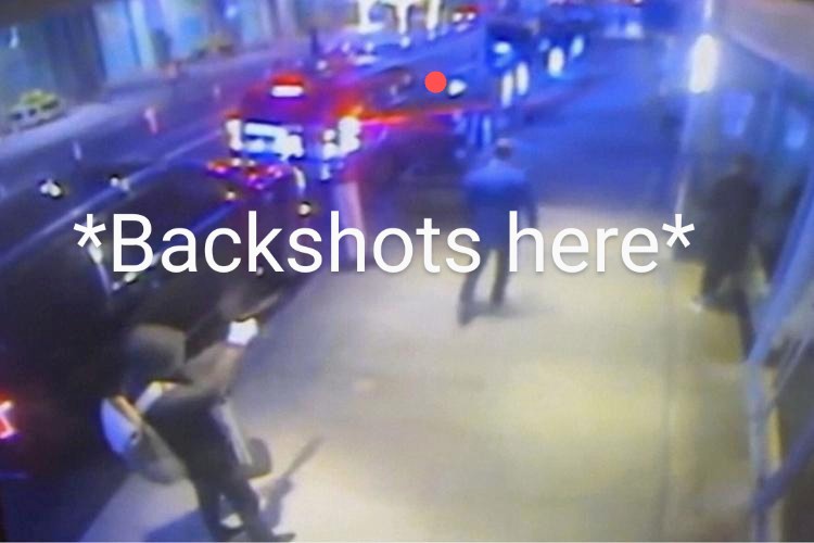 A low-resolution, blurry security camera image shows a nighttime street scene with police cars and flashing lights. A person…