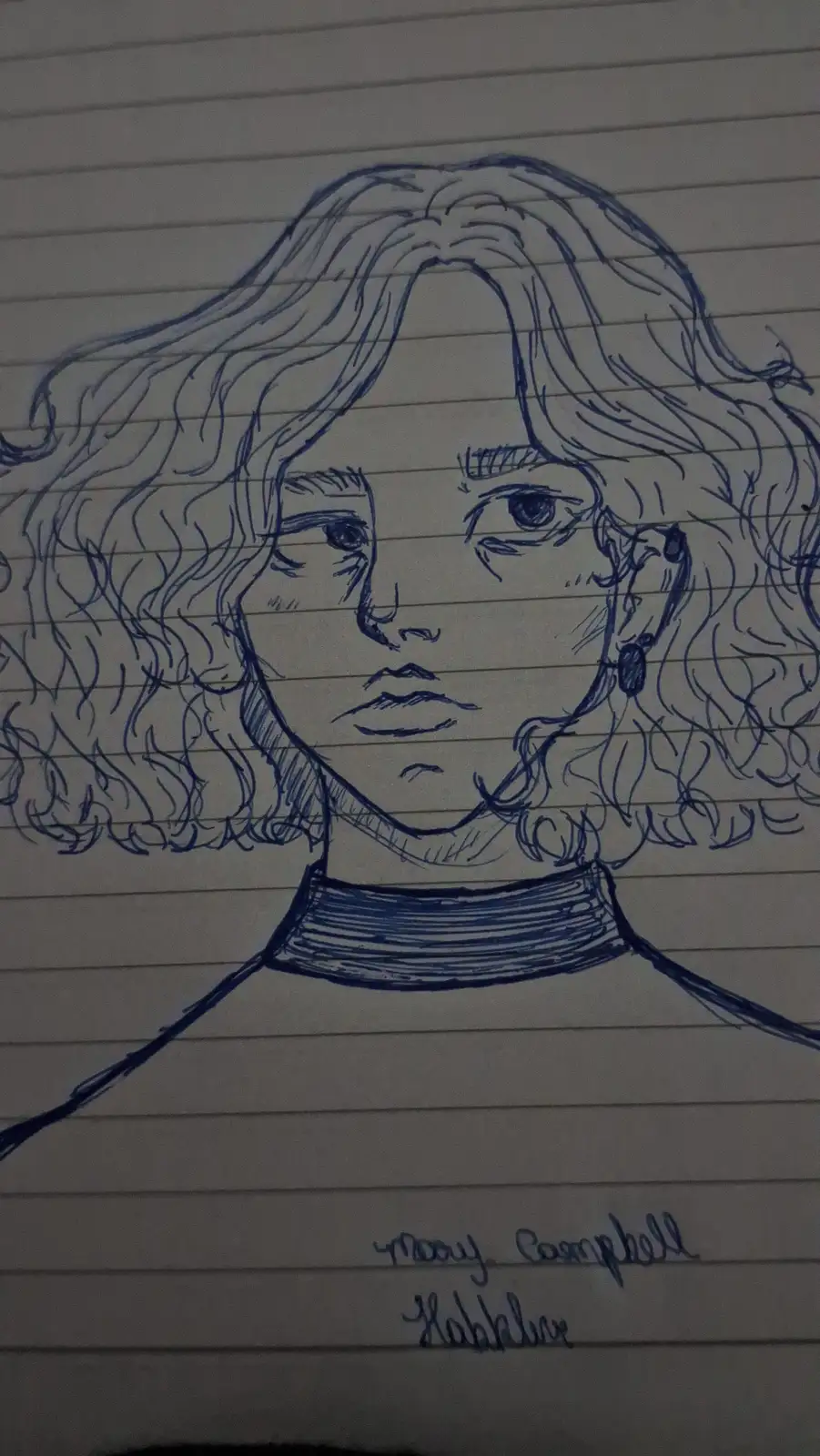 A hand-drawn portrait in blue ink on lined notebook paper depicts a person with curly hair, a neutral expression, and a…