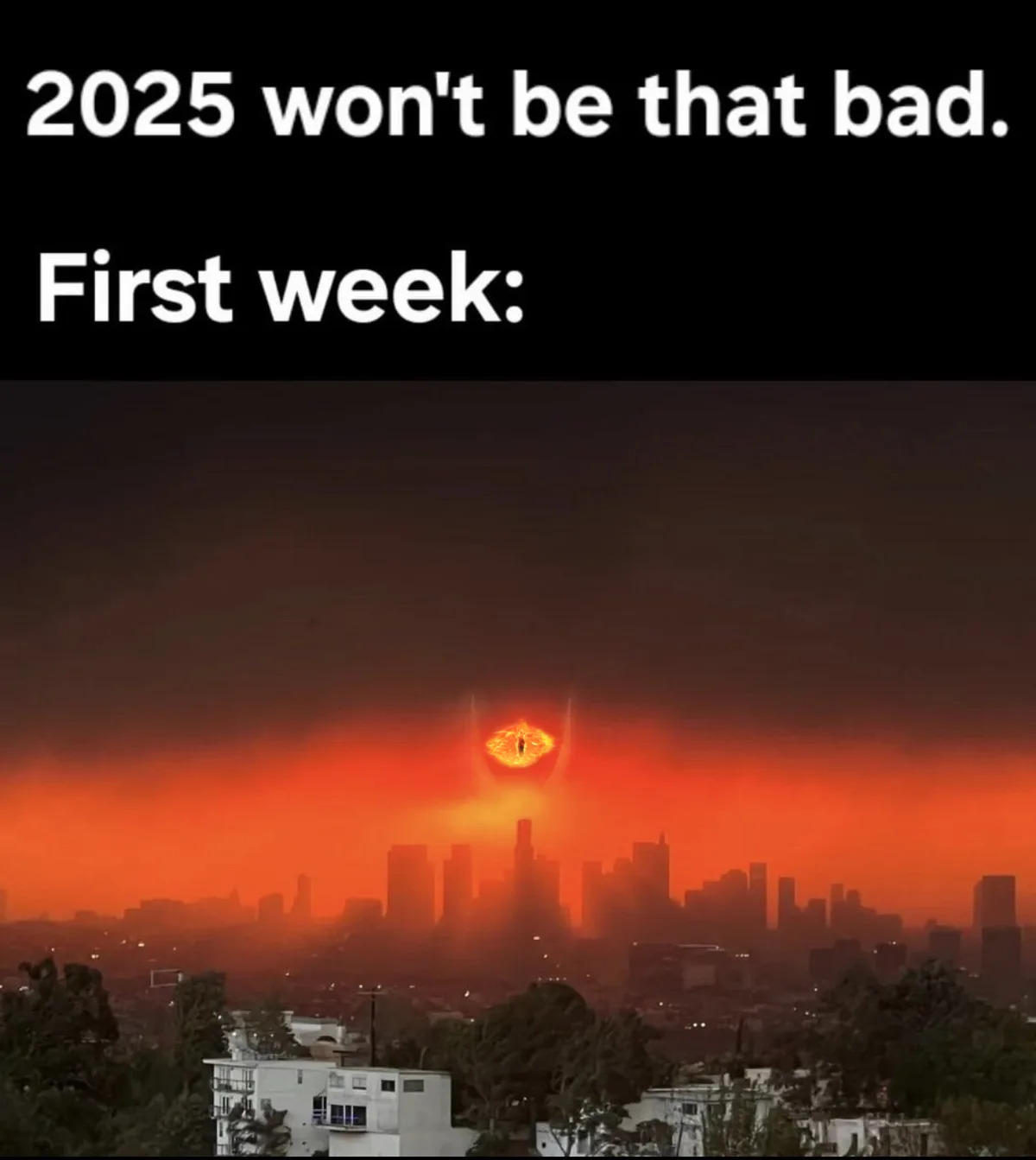 The image shows a city skyline under a dark, ominous sky with a large, glowing, fiery eye hovering above the buildings…